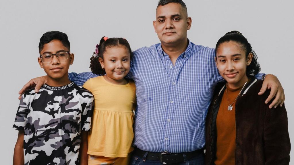father standing with his kids