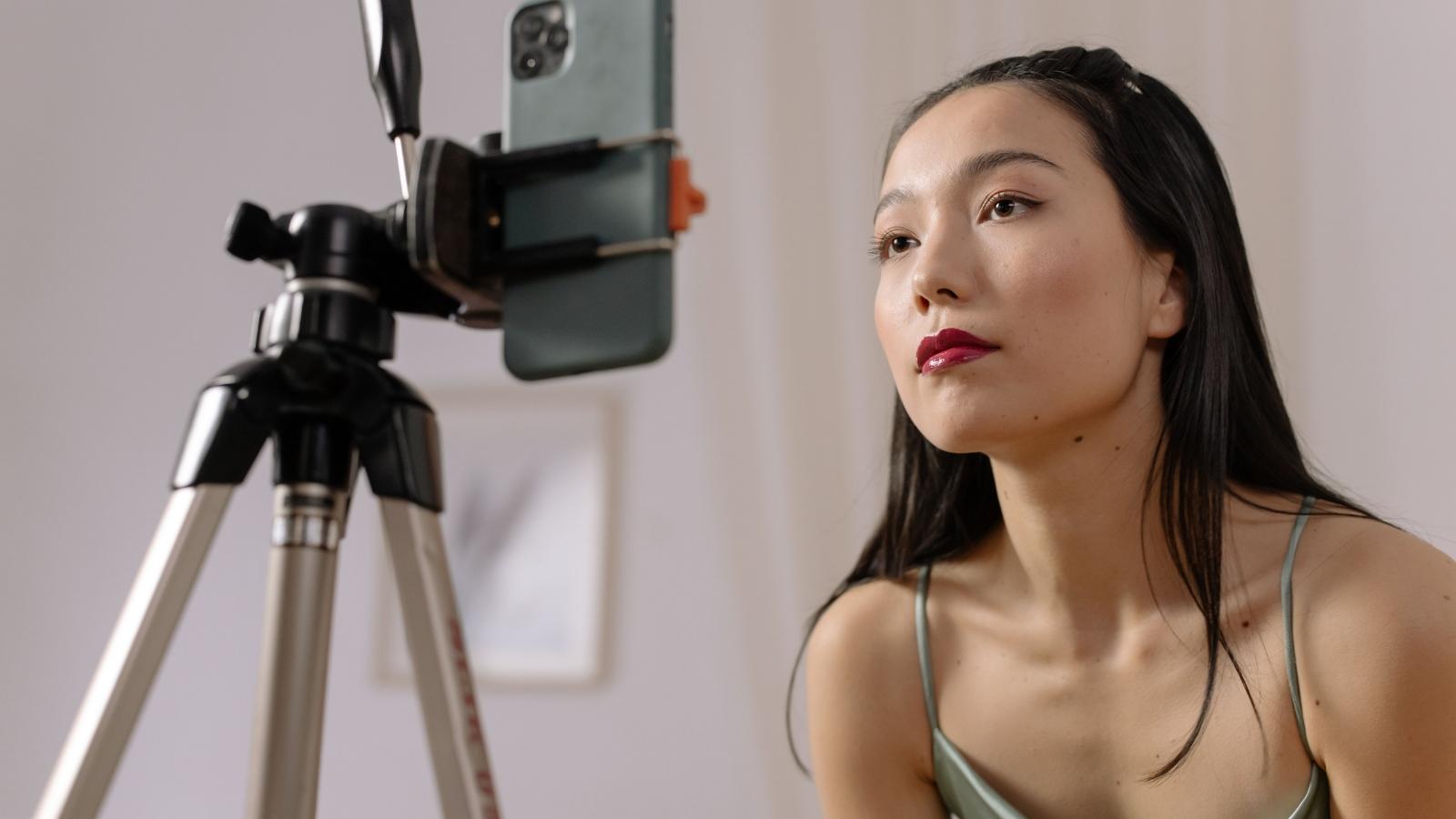 Hotel Front Desk Worker Tells Walk In Guest the Hotel Is Sold Out, Then Faces an Influencer Threat female influencer with her phone on a tripod