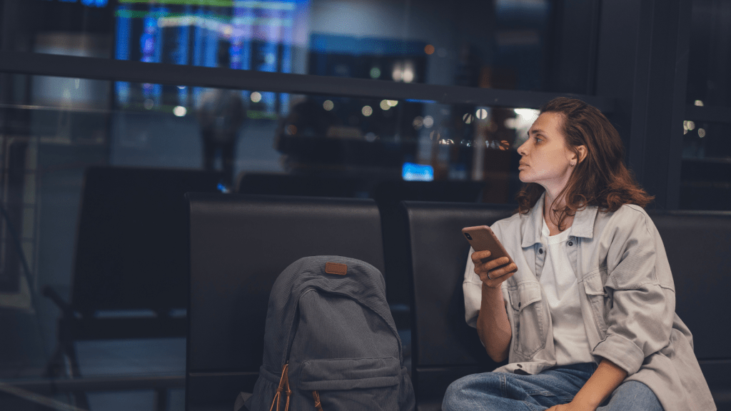 Her Flight Was Delayed for Hours—Then Her Friend Canceled Her Ride Home at the Last Minute female passenger waiting at airport at night