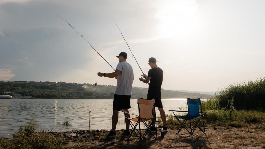 two men fishing in a pond