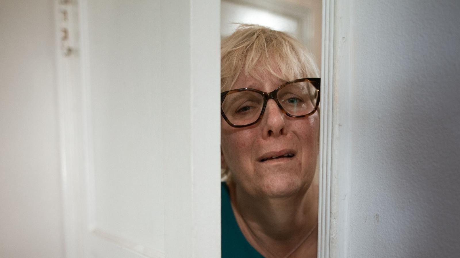 She Asked for a Basic Heads Up Before Her Stepson Let Himself Into Their Home—But Her Husband Accused Her of Overreacting to a Non Issue frightened woman opening the door