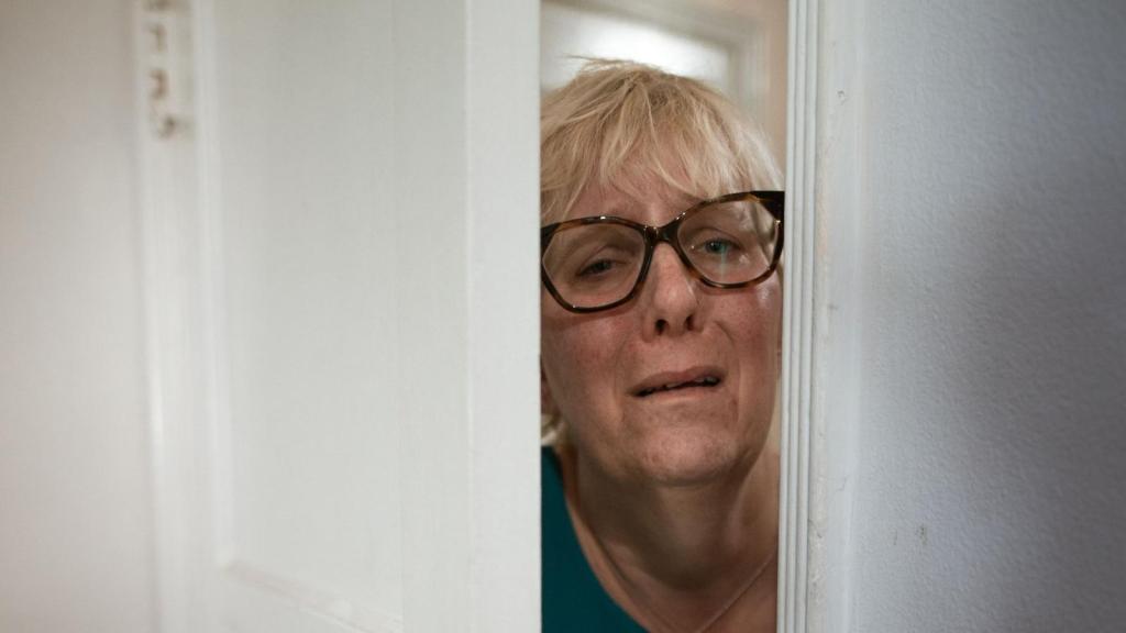 frightened woman opening the door