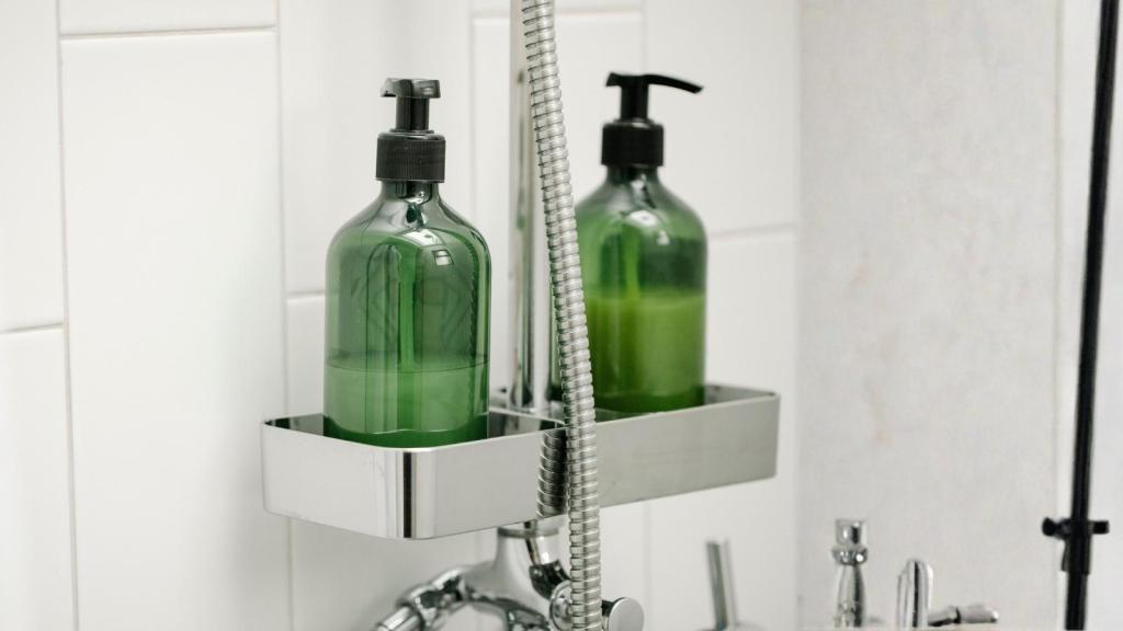 green shampoo bottle in the shower