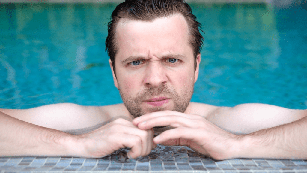grumpy man at swimming pool