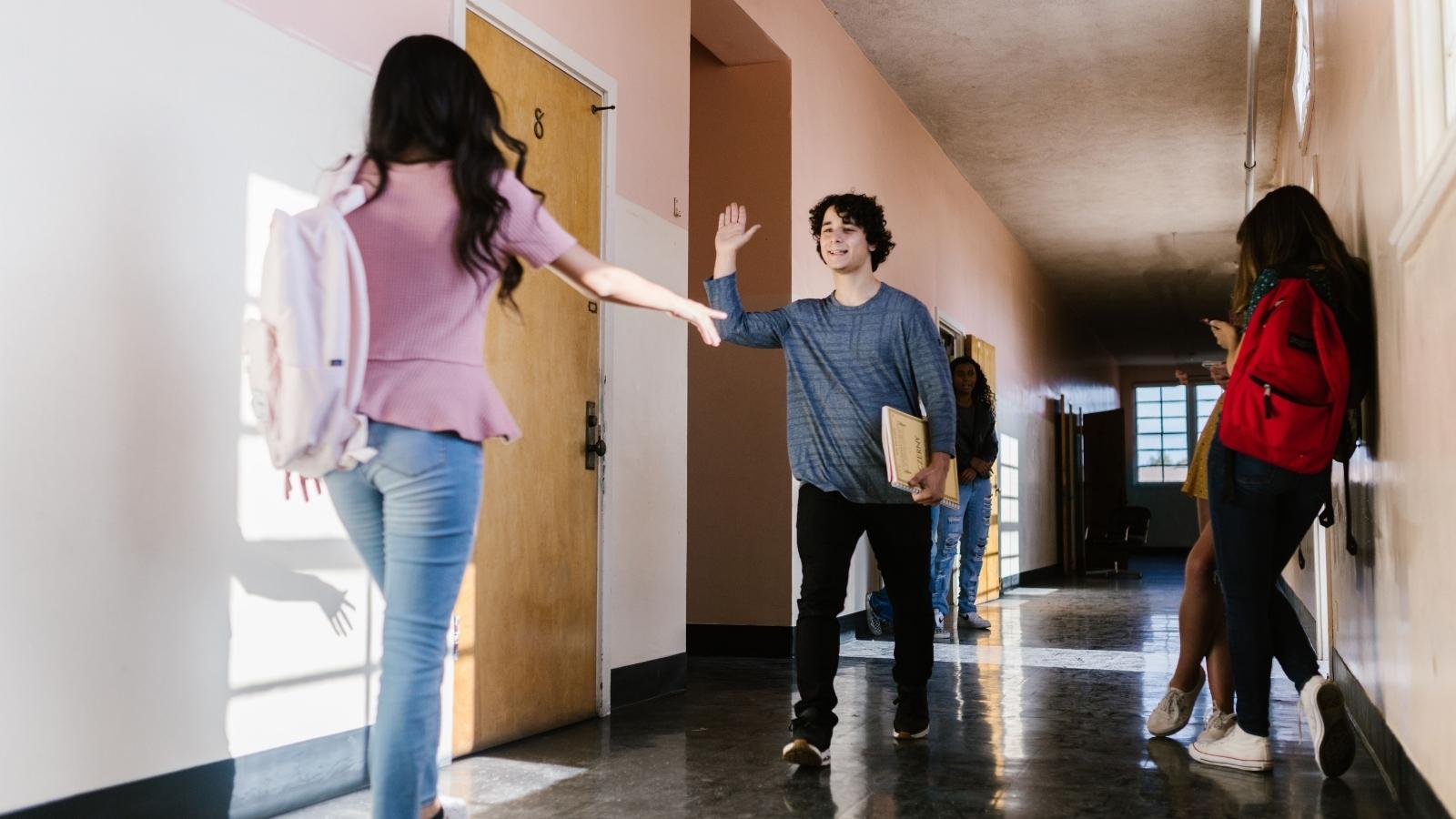 high school student walking down hallway