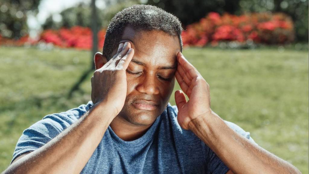 irritated man rubbing temples