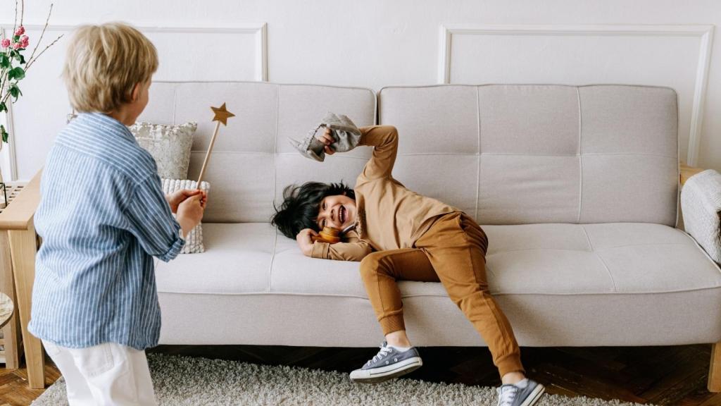 kids laughing and playing on the couch