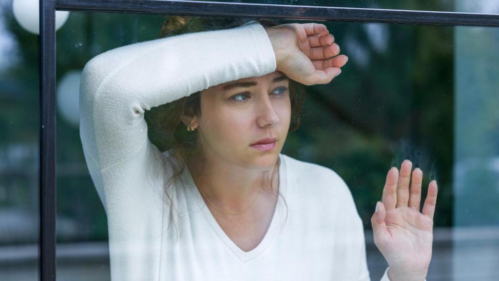 woman looking out a window
