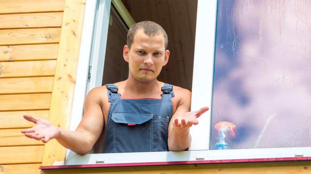 man looking out a window
