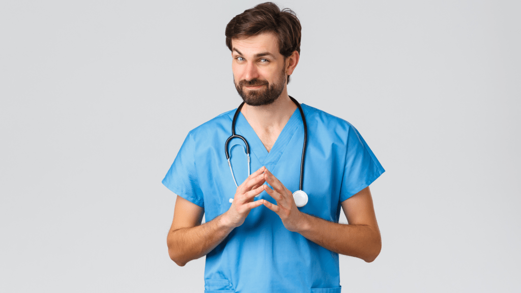 male doctor smirking smiling with fingers together