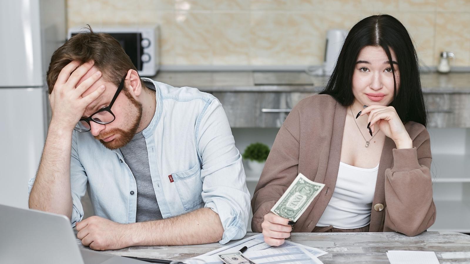man and woman stressed about money