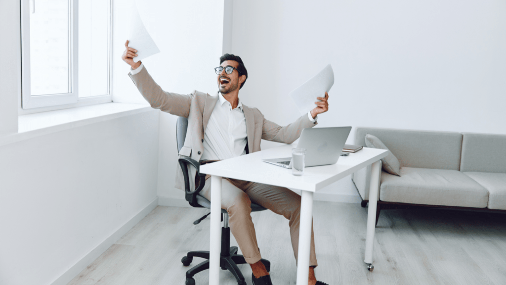 A Company Cracked Down On Expenses. One Employees Perfect Compliance Cost Them A Fortune. man gleefully happily doing paperwork