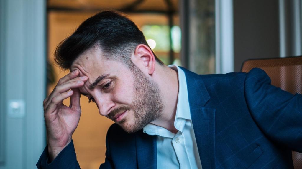 man looking stressed in a tux
