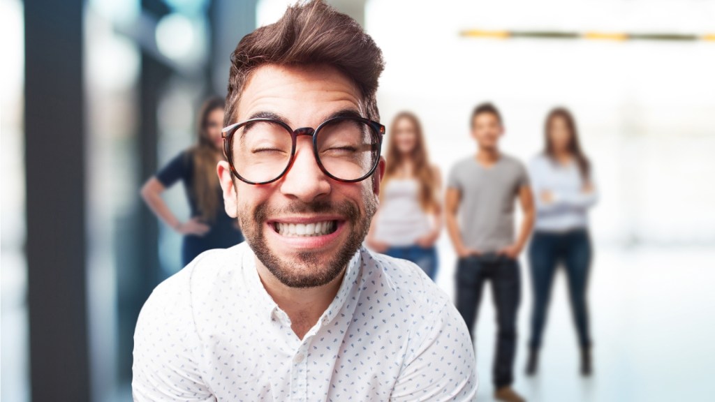 man smiling wide in the office break room