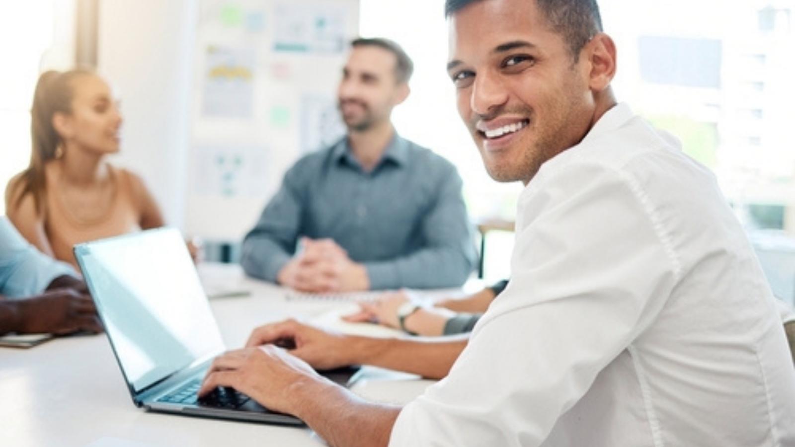 He Was Asked to Take Meeting Minutes, So He Documented His Boss Insulting the Team—Then She Got Fired Man smiling at a meeting