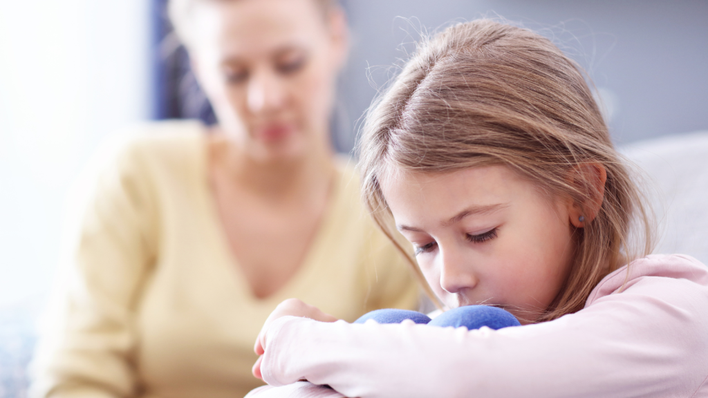 mom and young girl sad together