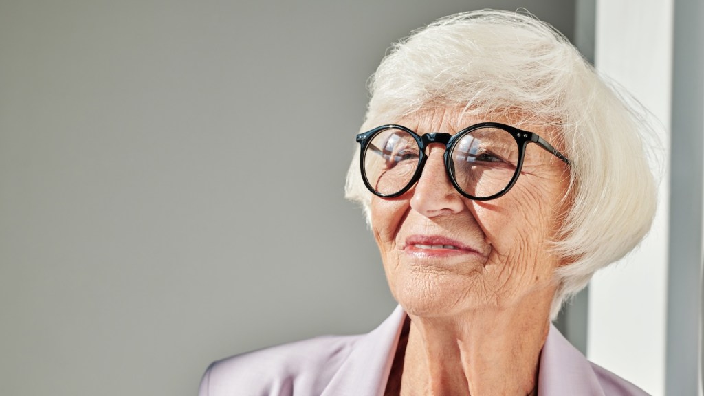 older woman/grandmother with white hair and glasses smiling