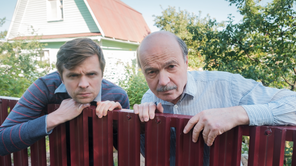 nosy neighbors leaning over fence