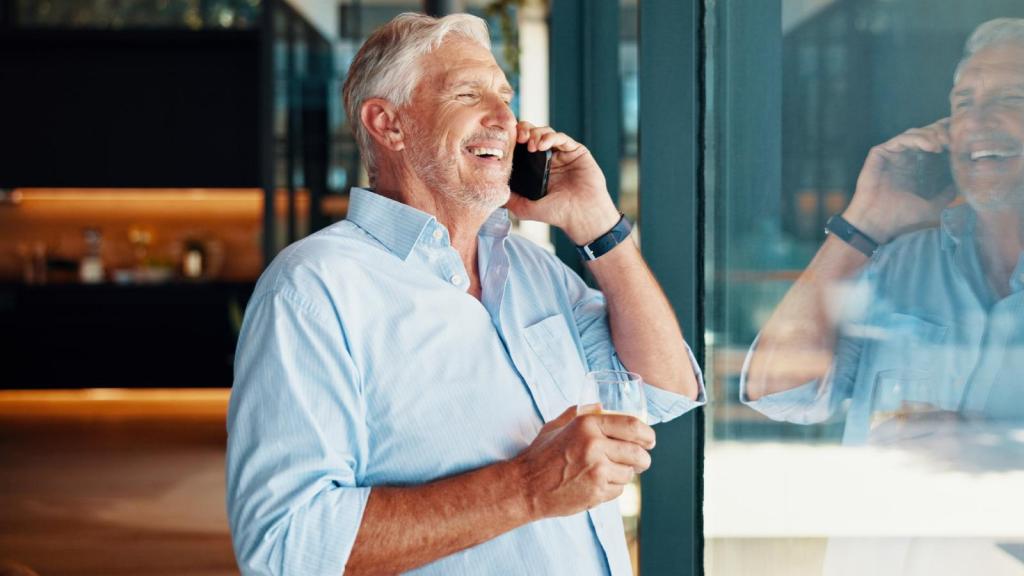 man laughing on a phone call