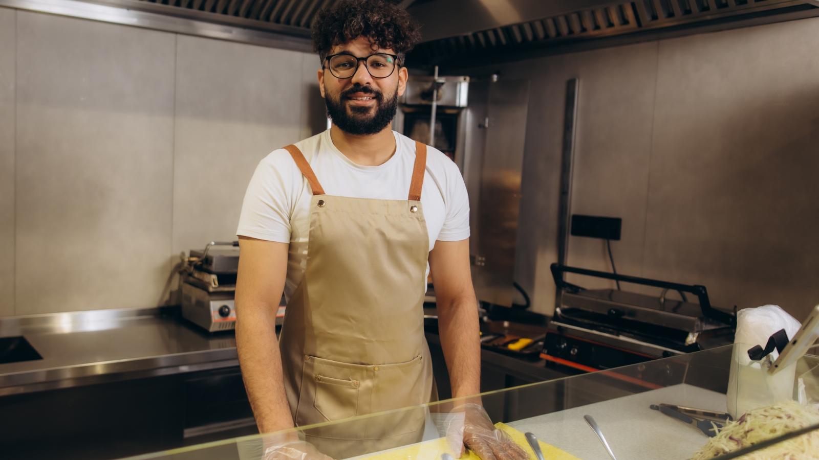 A Scammer Tried to Pay With Counterfeit Cash—Then Lost His Mind When the Cashier Refused to Give It Back man working in a restaurant