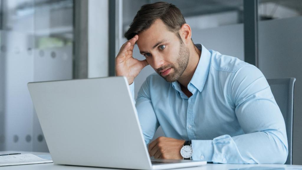 man frustrated at his desk