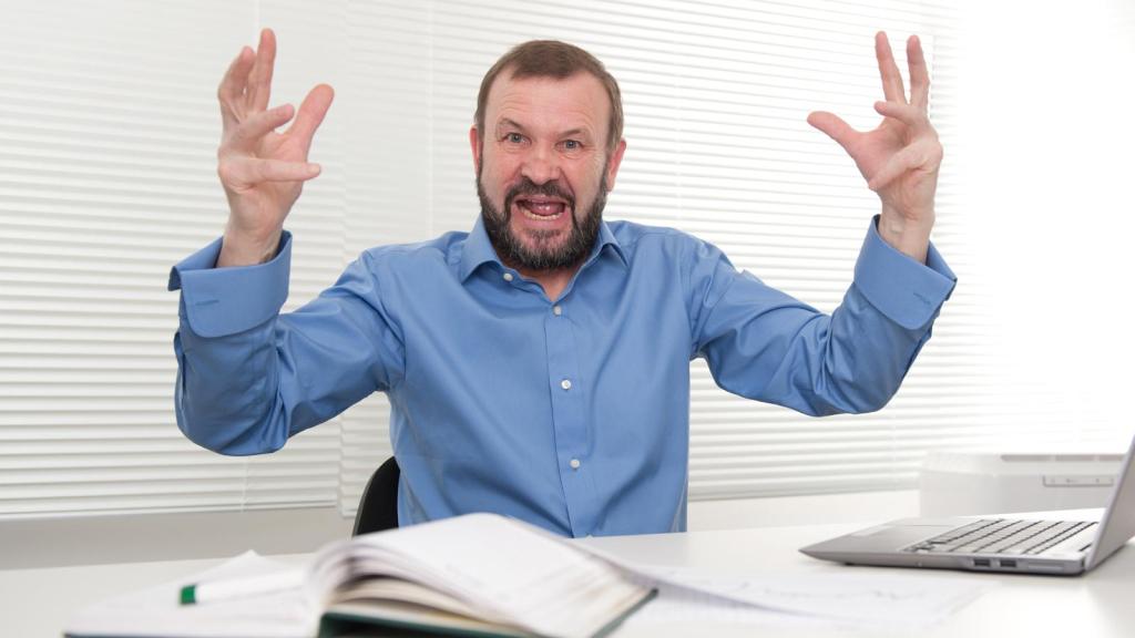 man upset at a desk