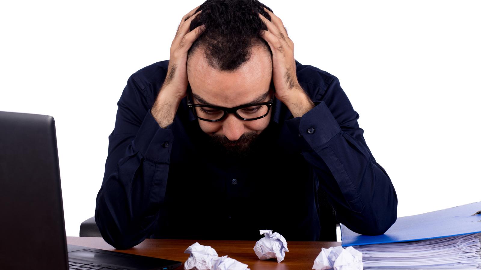 A Workers Nightmarish New Job Caused Daily Panic Attacks—And His Rigid Schedule Was Specially Designed to Stop Him From Ever Interviewing Elsewhere man with his head down