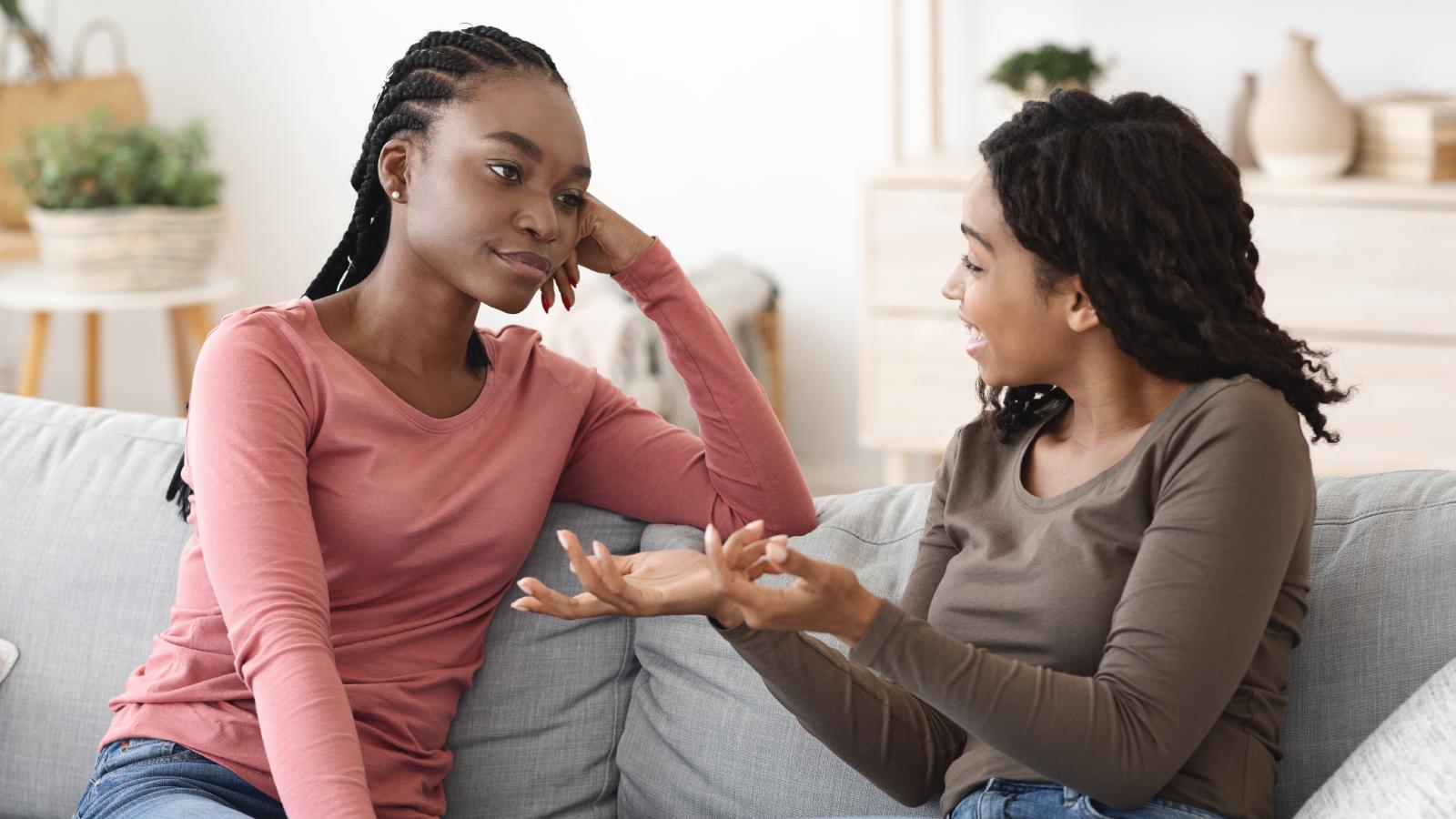 She Invites Friends Over to Her Own Apartment—But Her Roommate Keeps Making It a Problem two women having a conversation