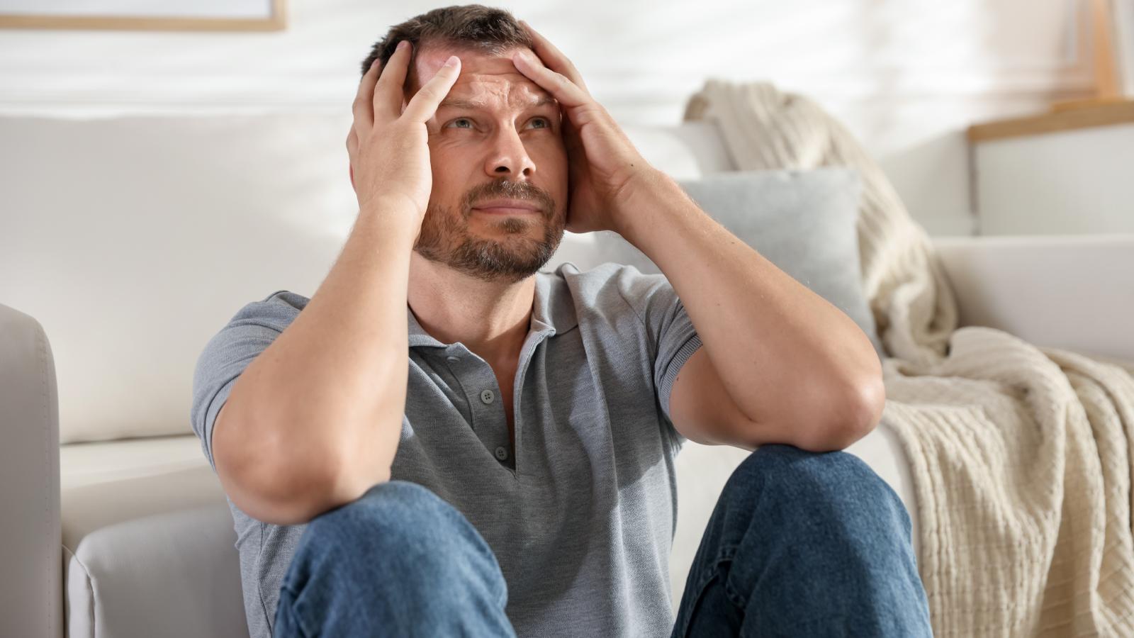 man stressed out in his apartment