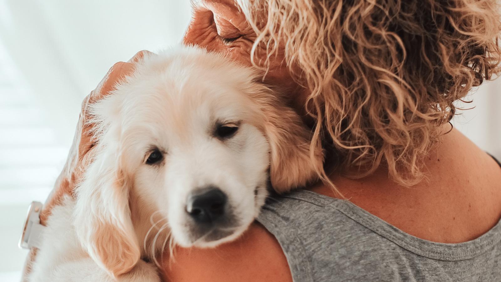 She Was Tired of Paying for Her Parents’ Dog—So She Told Them She’s Deducting the Expenses from Her Rent woman holding a dog