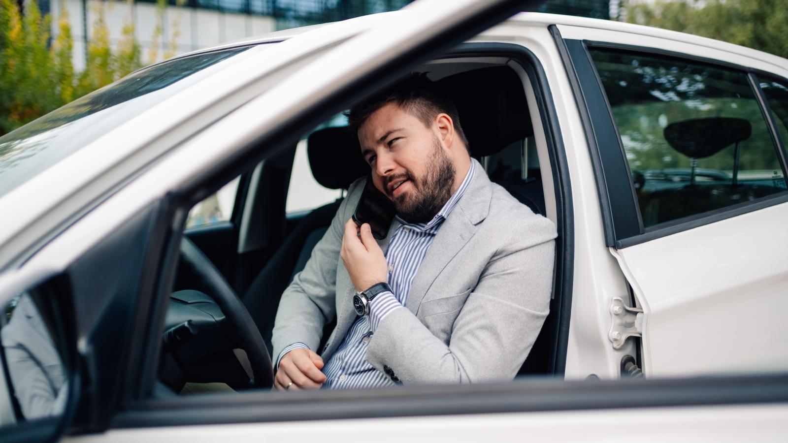 man in his car