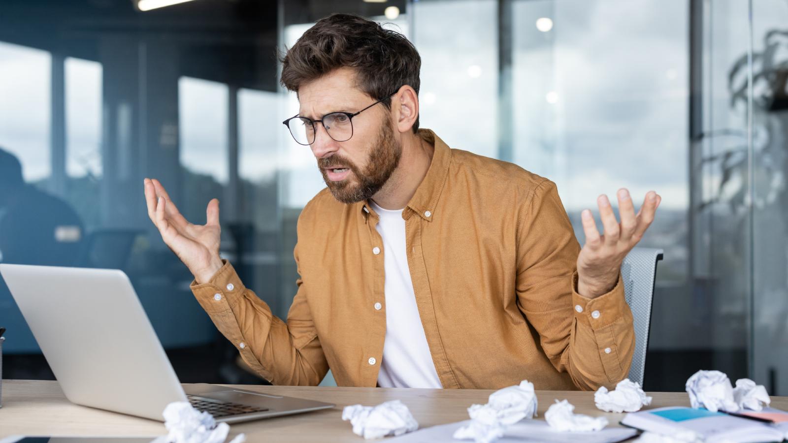 Hes Barely Scraping By on His Paycheck, Yet Hes Terrified His Multimillionaire Boss Could Fire Him at Any Moment—Raising the Question of Why the Power Imbalance Feels So Stacked Against Him man frustrated at his desk