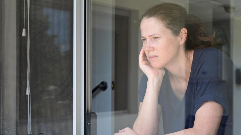 woman looking out a window