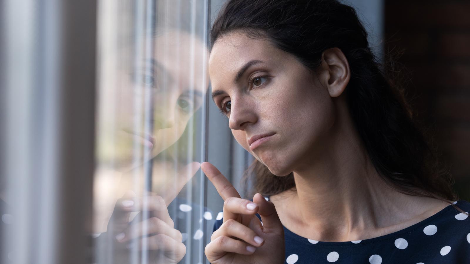 woman looking out a window