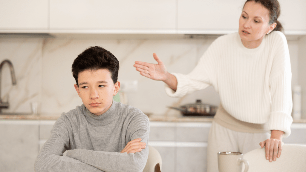 offended teen boy turning away from his mother