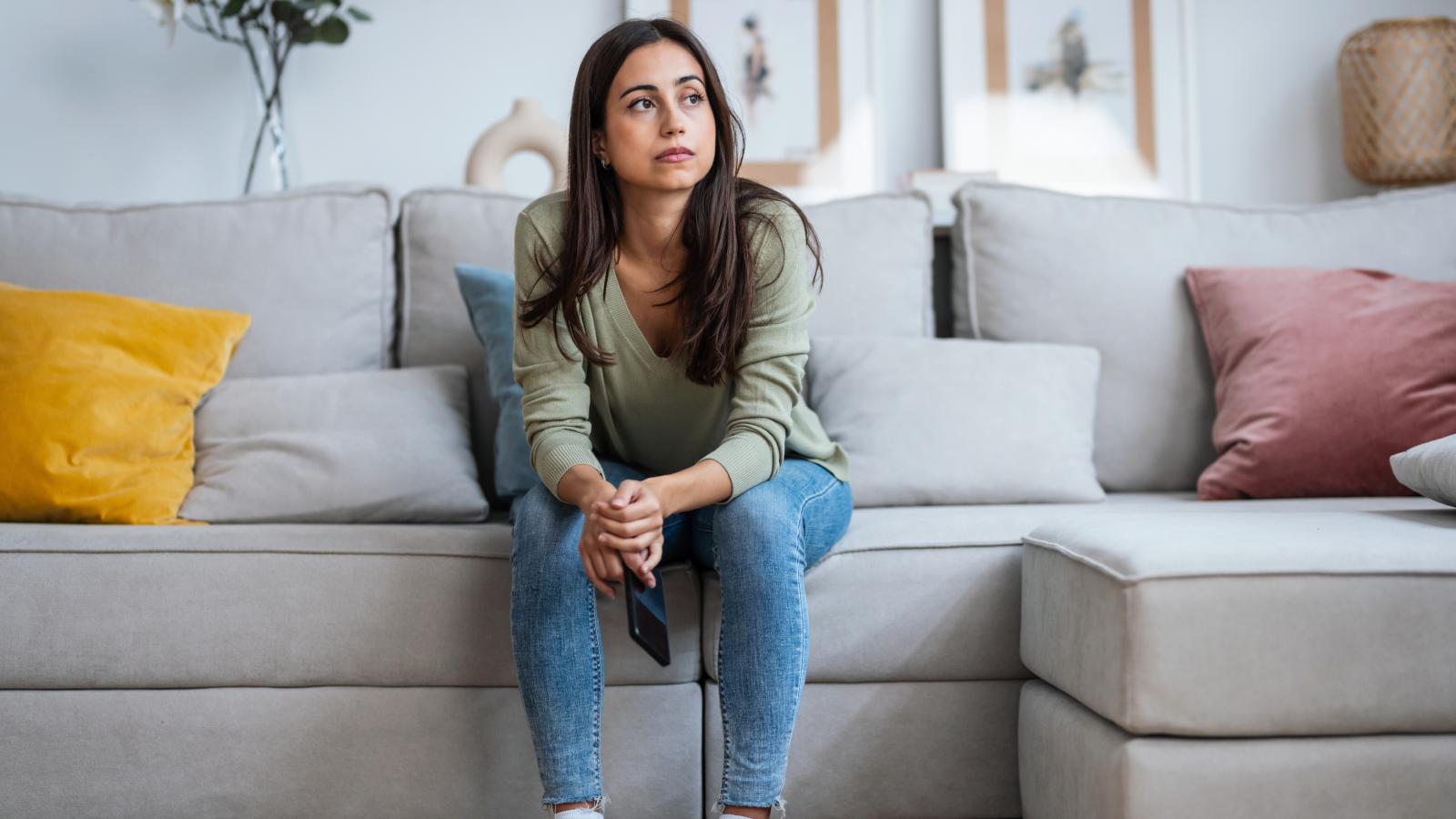 She Signed a Sublease Agreement. Now the Owner Is Trying to Push Her Out Early. woman sitting on a couch