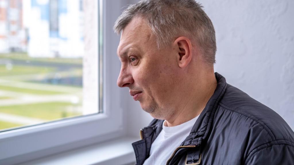 man looking out a window