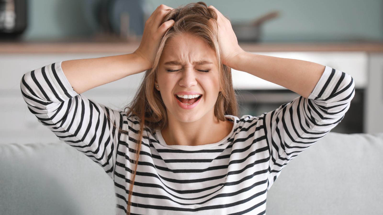 Her Neighbor Wont Stop Harassing Her Family, And The Apartment Manager Refuses To Do Anything About It woman with her hands on her head