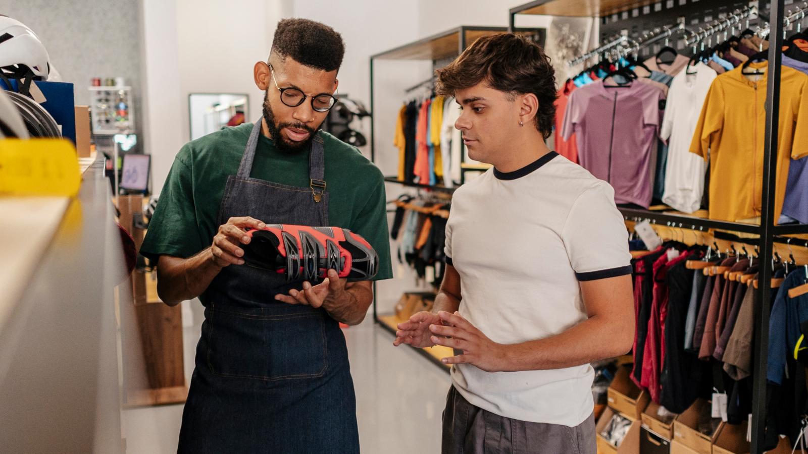 worker helping man in a store
