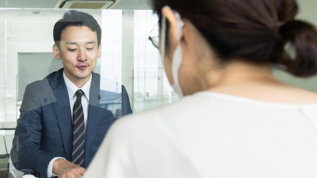man talking to a bank teller