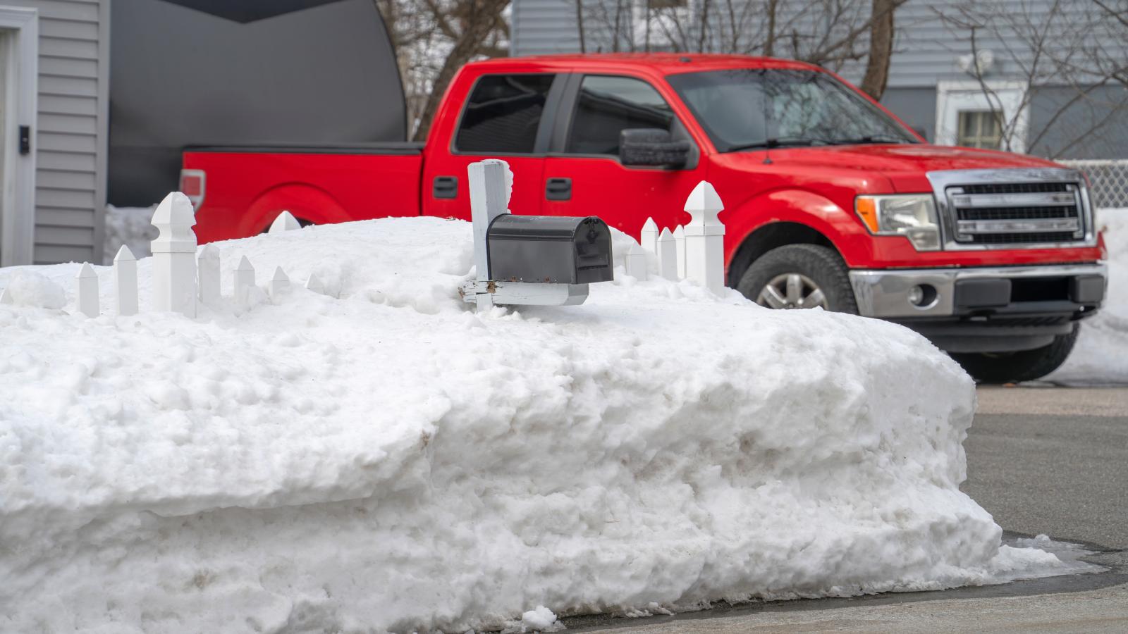 snow piled high in a yard