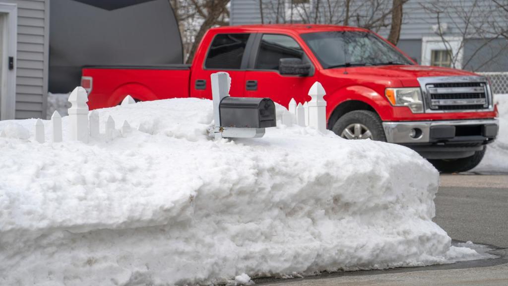 snow piled high in a yard