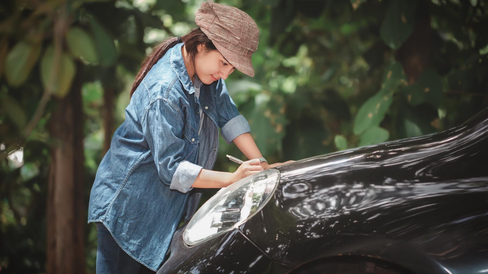 woman next to a car