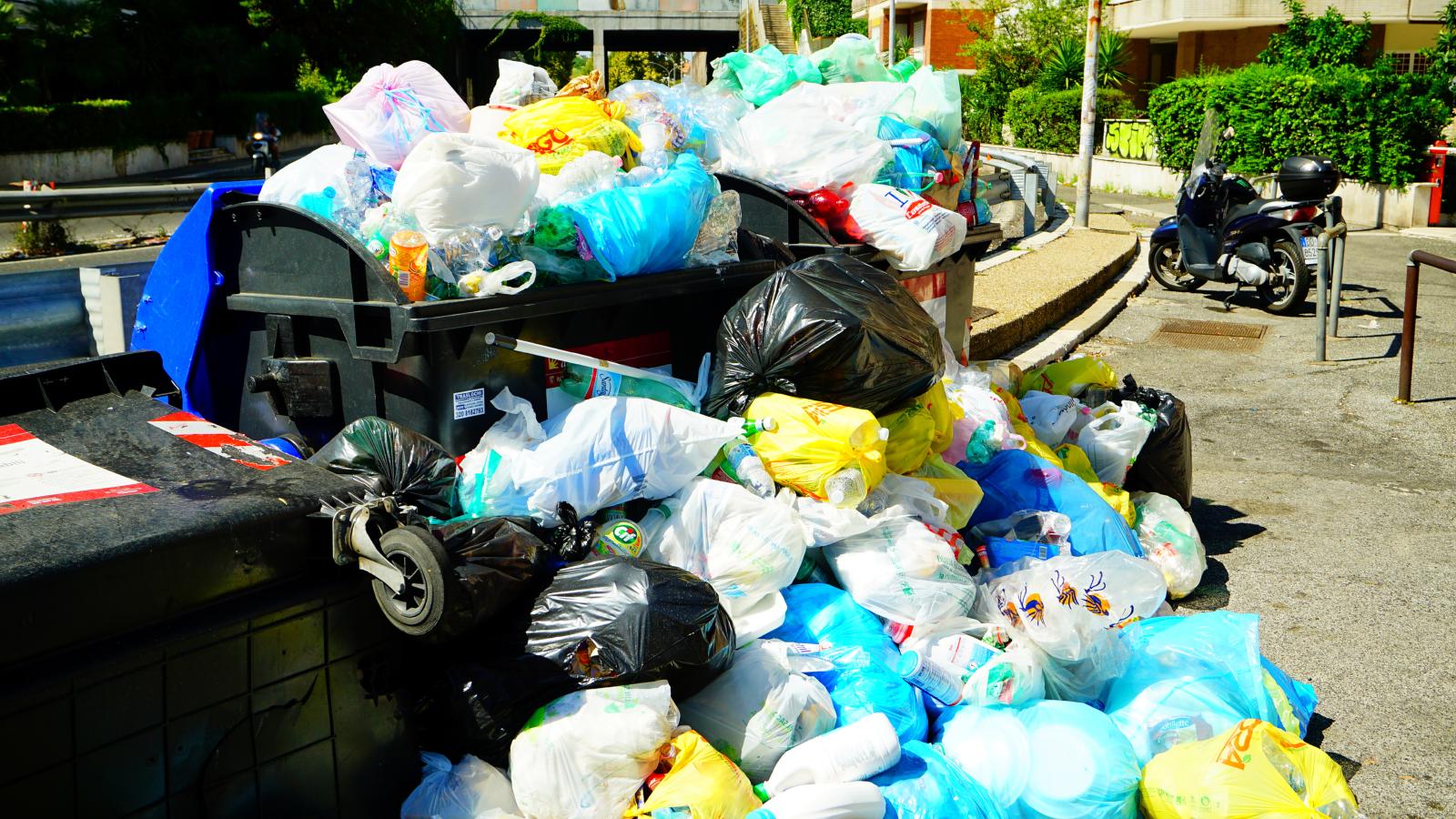 He Was Tired of the Neighbors Scooter Blocking His Trash Cans—Then He Blocked in the Scooter with Heavy Garbage and Served a Municipal Code Audit trash piled high by a dumpster