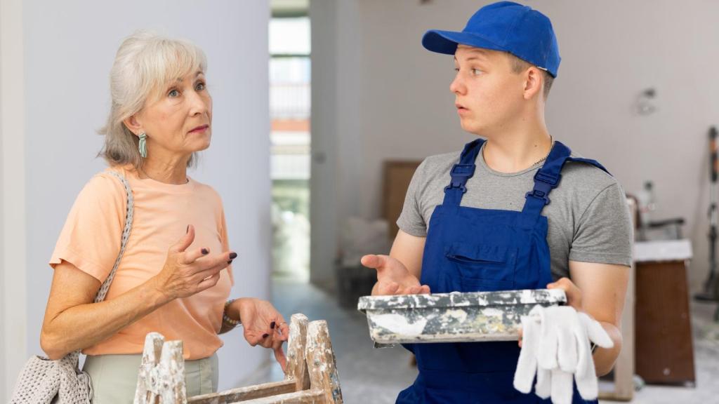 woman talking to a house painter