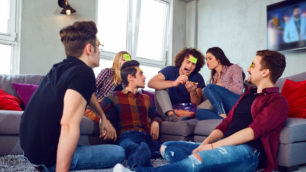 roomates in living room playing game confused