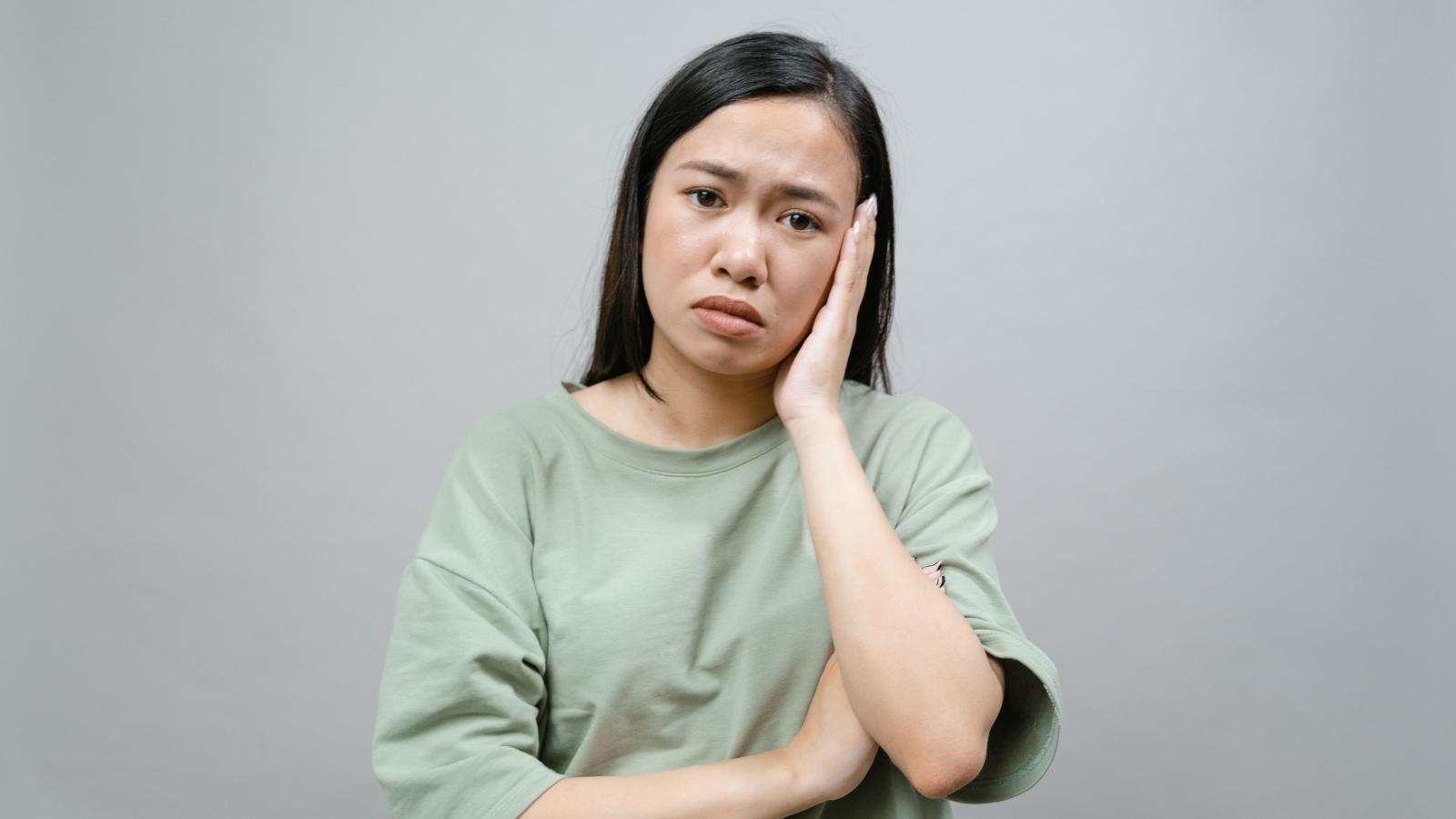 I Gave Them Everything: Woman Villainized by Boyfriend’s Family After Setting One Simple Boundary sad looking woman in light green shirt