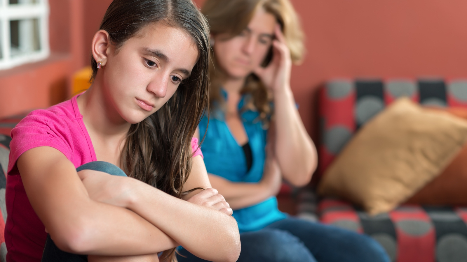 His Mom Controls His Money and Plays Favorites — Hes a Teenager Already Planning to Walk Away From the Family sad teen girl with mom on couch