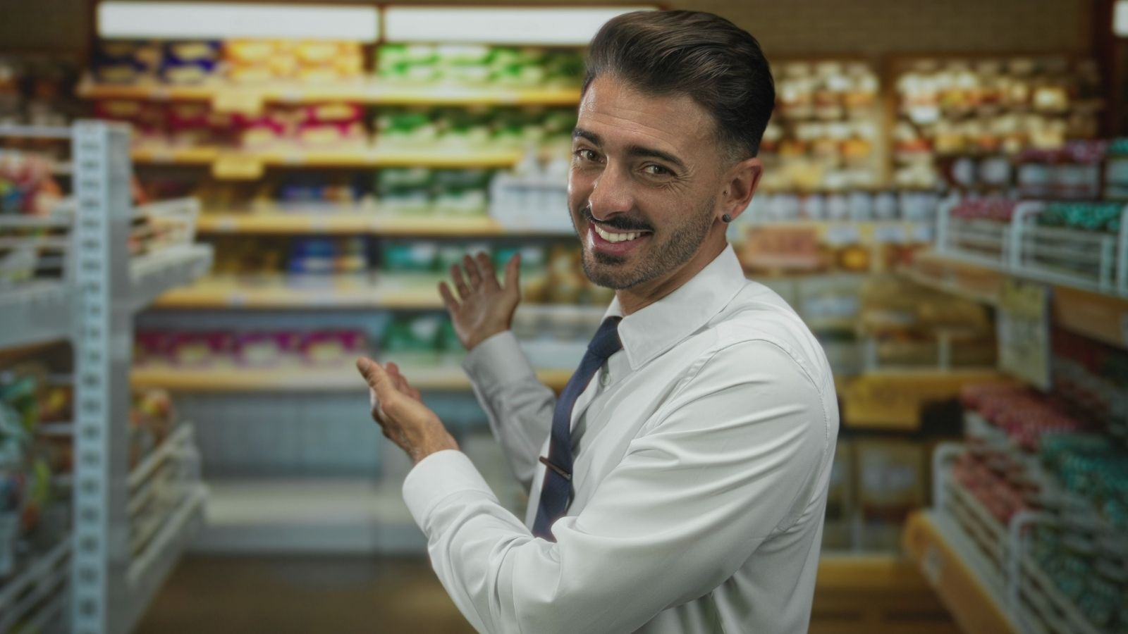 man showing off stocked shelves