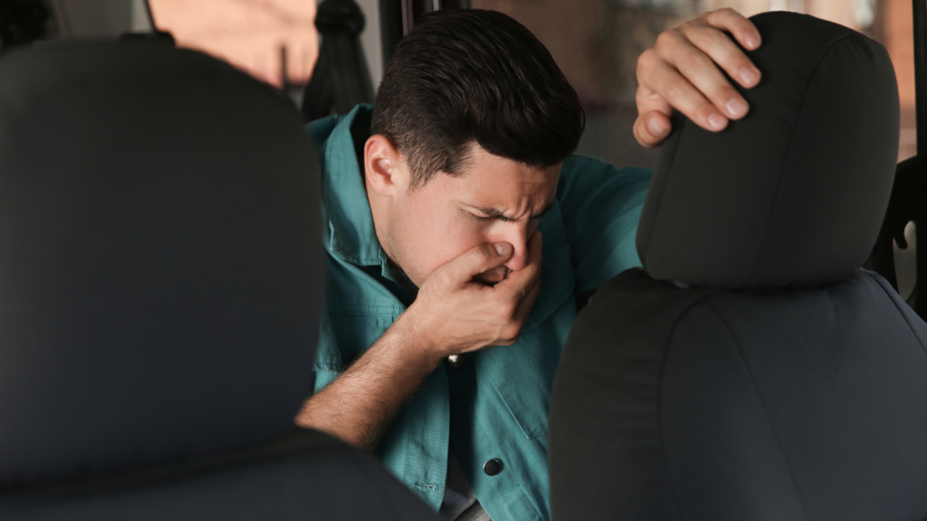 They Planned a Long Road Trip Together — The One Who Gets Carsick Got Stuck in the Middle Back Seat sick in the backseat of a car